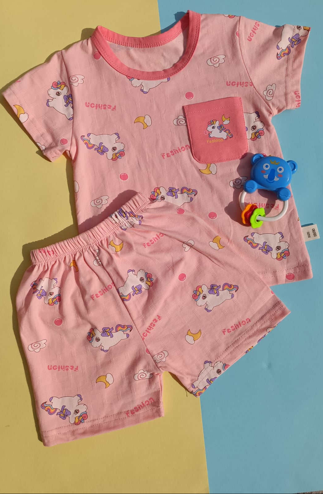 Children's pink pajama set with cartoon designs on a multicolored background