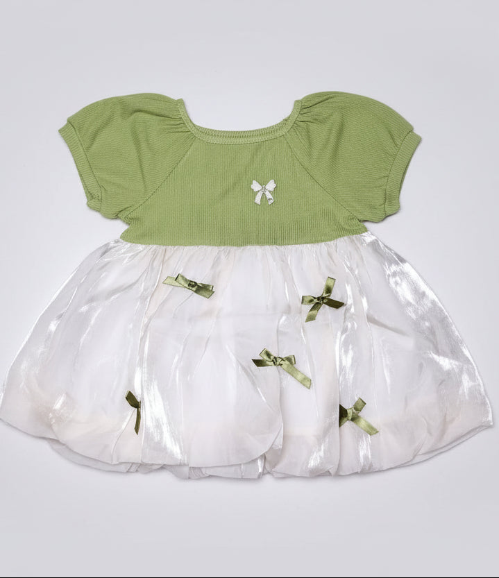 Green top and white skirt with decorative elements on a black background