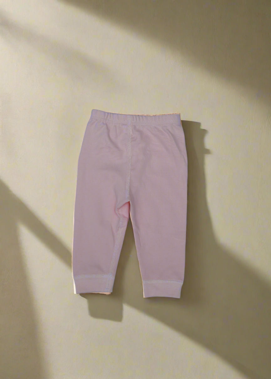 Pink leggings on a light blue background