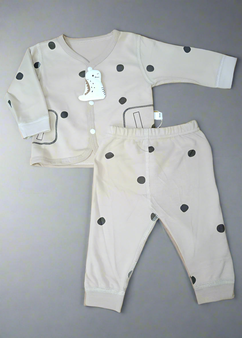 Baby outfit set with long-sleeve shirt and pants on a yellow patterned background