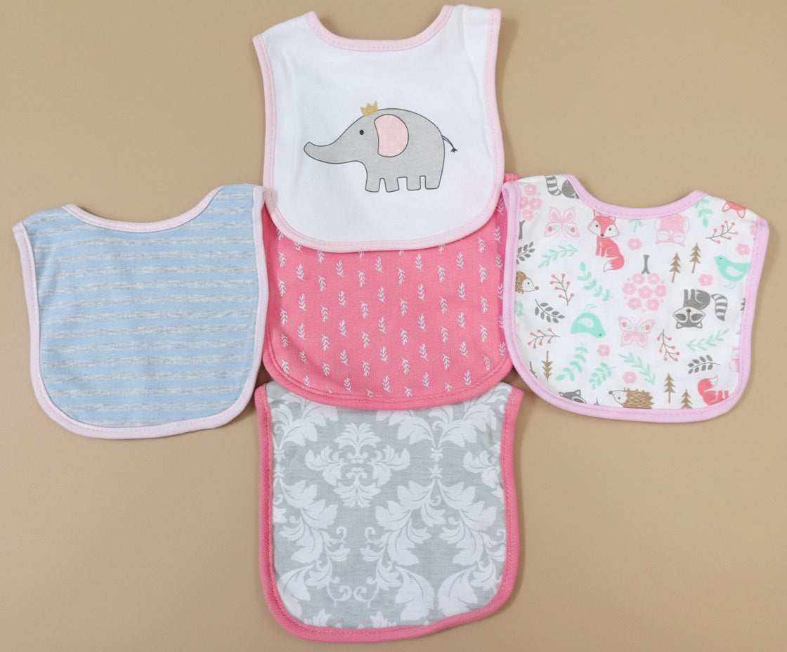 Set of five baby bibs with different patterns on a textured surface