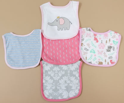 Set of five baby bibs with different patterns on a textured surface