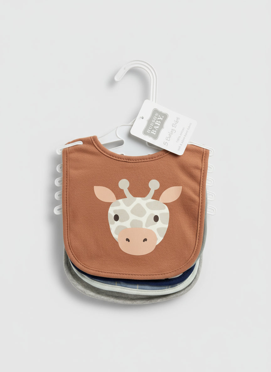 Brown bib with giraffe design on a hanger against a textured surface