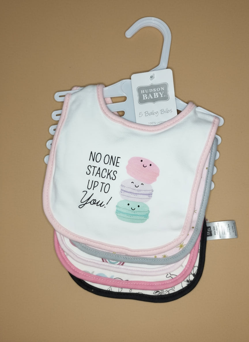 Stack of baby bibs with a 'No one stacks up to you!' message on a hanger.