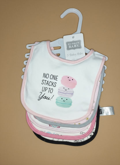 Stack of baby bibs with a 'No one stacks up to you!' message on a hanger.