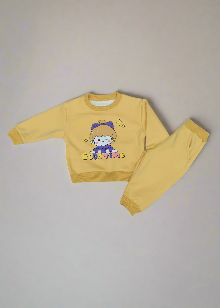 Yellow children's outfit with cartoon design on a white surface