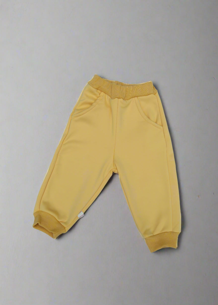 Yellow baby pants on a light  background
