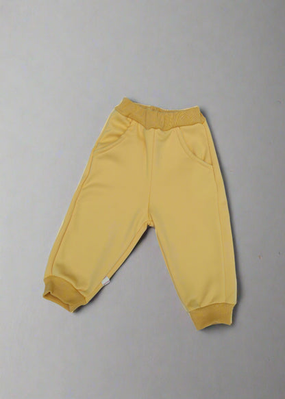 Yellow baby pants on a light  background