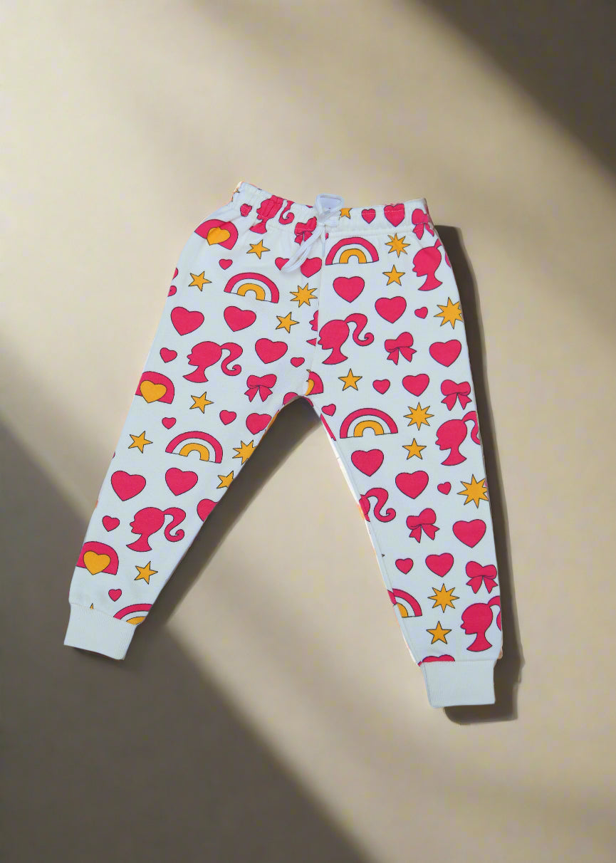 Pair of white leggings with pink hearts and yellow stars on a light blue background