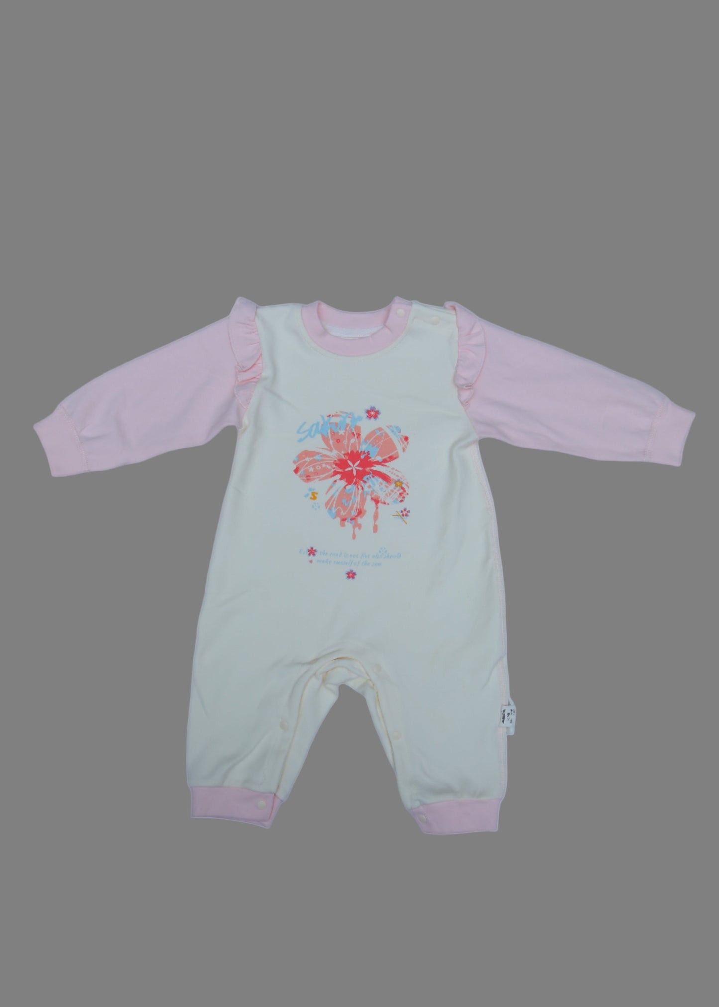 Light green and pink baby outfit with floral design on a light blue background