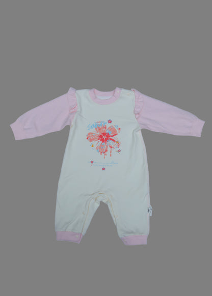 Light green and pink baby outfit with floral design on a light blue background