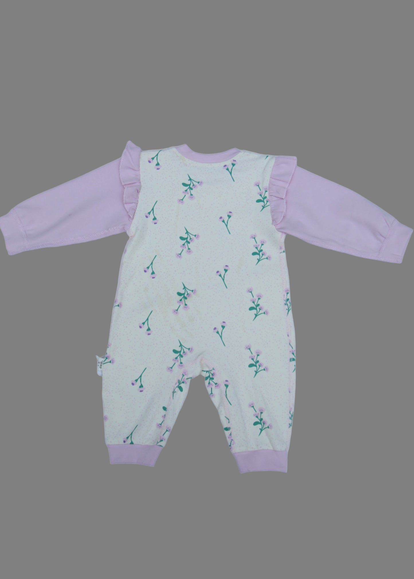 Children's outfit with pink pants and patterned top on a white background