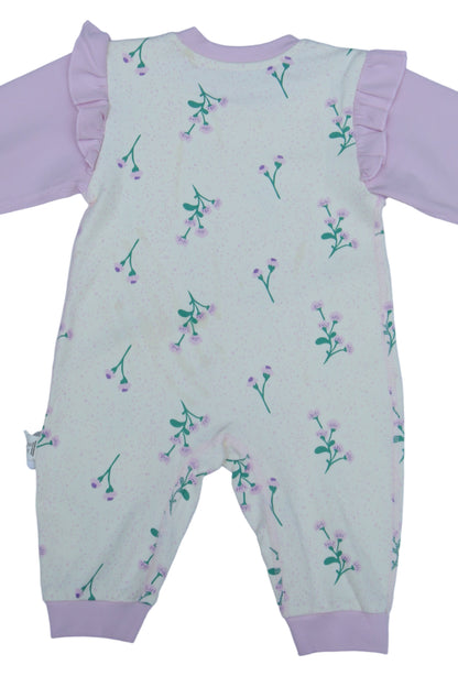 Children's outfit with pink pants and patterned top on a white background