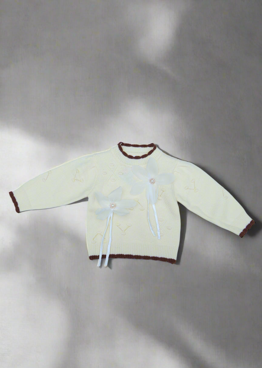 White garment with brown accents on a light blue background