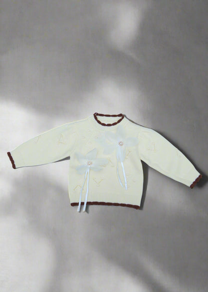 White garment with brown accents on a light blue background