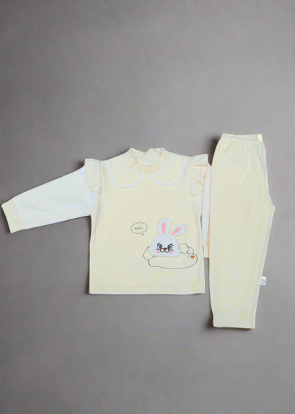 Yellow baby outfit with cartoon design on a light blue background