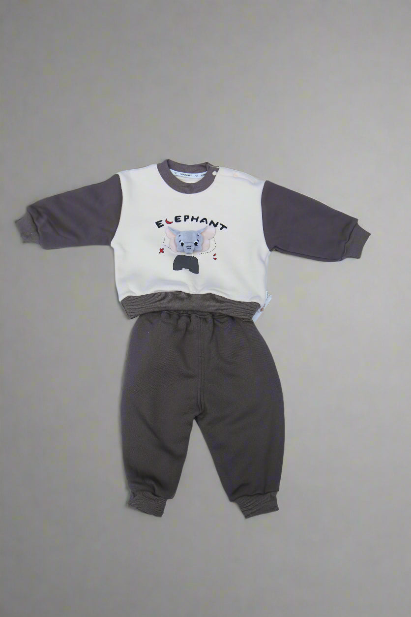 Children's outfit with a white shirt and gray pants on a light blue surface.