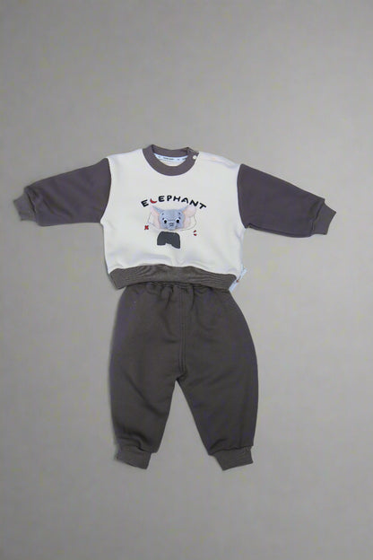 Children's outfit with a white shirt and gray pants on a light blue surface.
