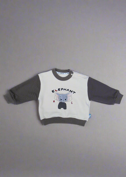 Children's outfit with a logo on a light blue surface