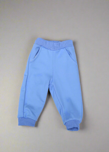 Light blue baby pants on a light blue background