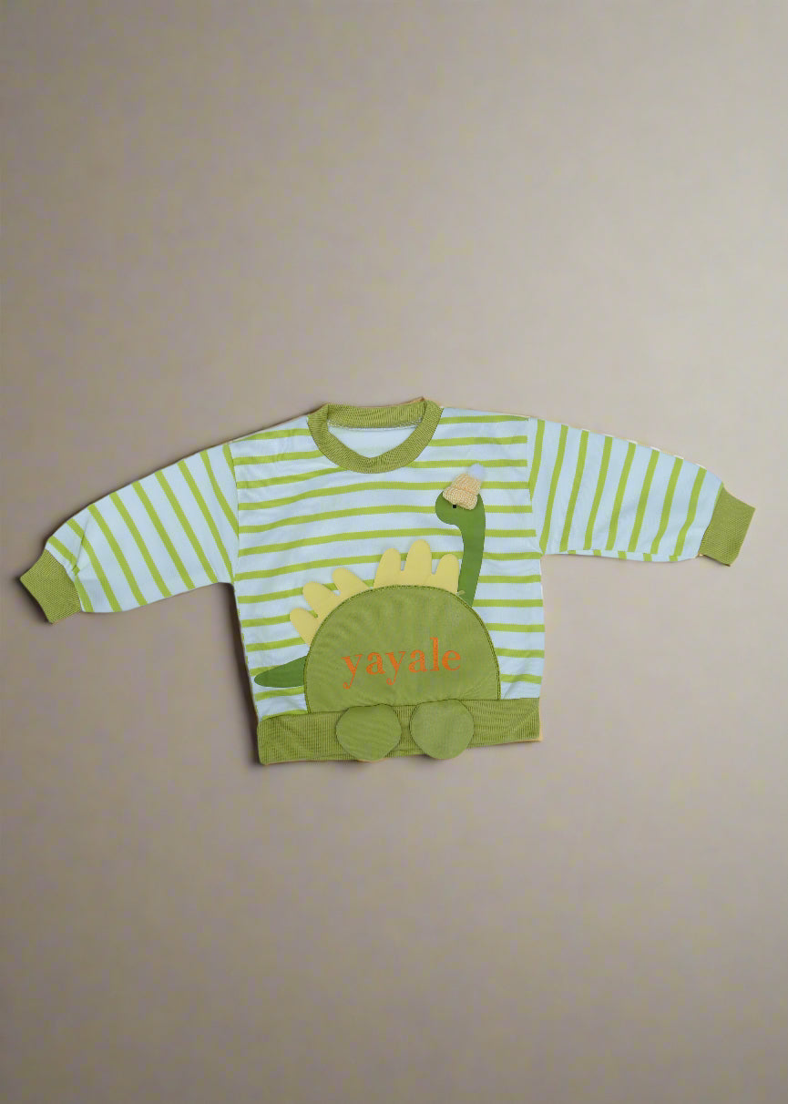 Green and white striped children's outfit with dinosaur design on a light blue background