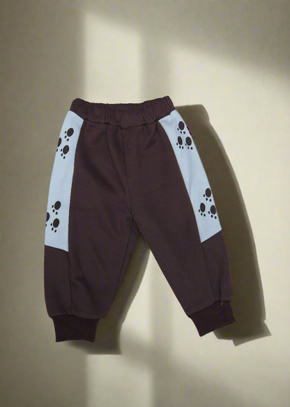 Brown pants with paw print design on a light blue background