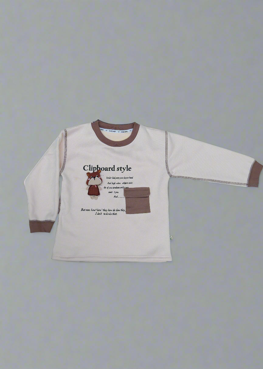 Beige long-sleeve shirt with brown accents on a light blue surface