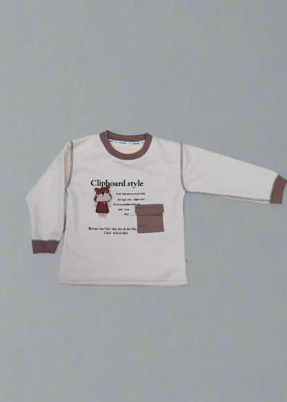 Beige long-sleeve shirt with brown accents on a light blue surface