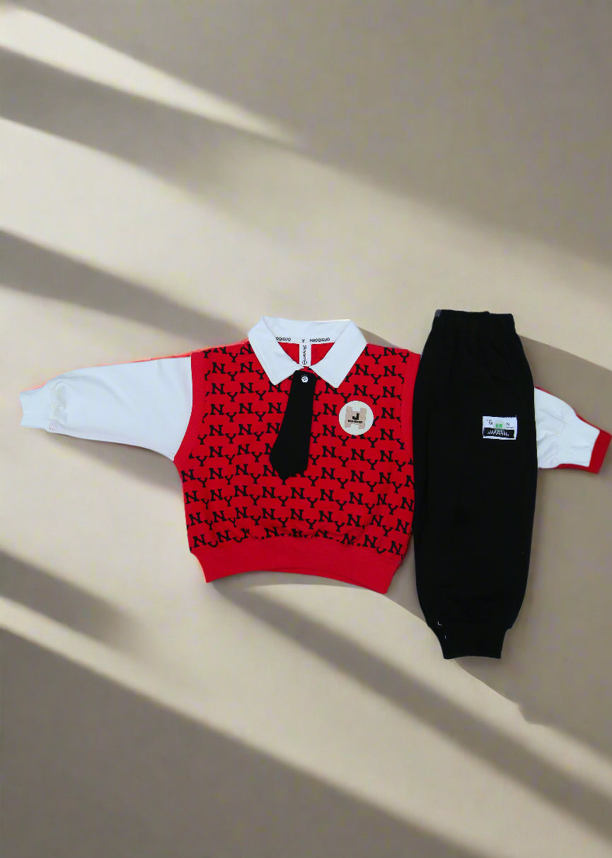 Red sweater with black pattern and white buttons on a white surface