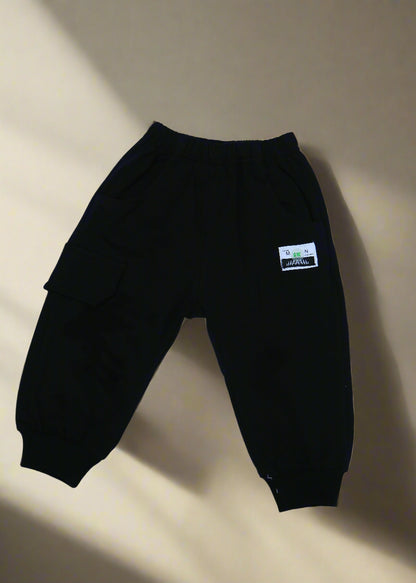 Black pants with a label on a light blue background