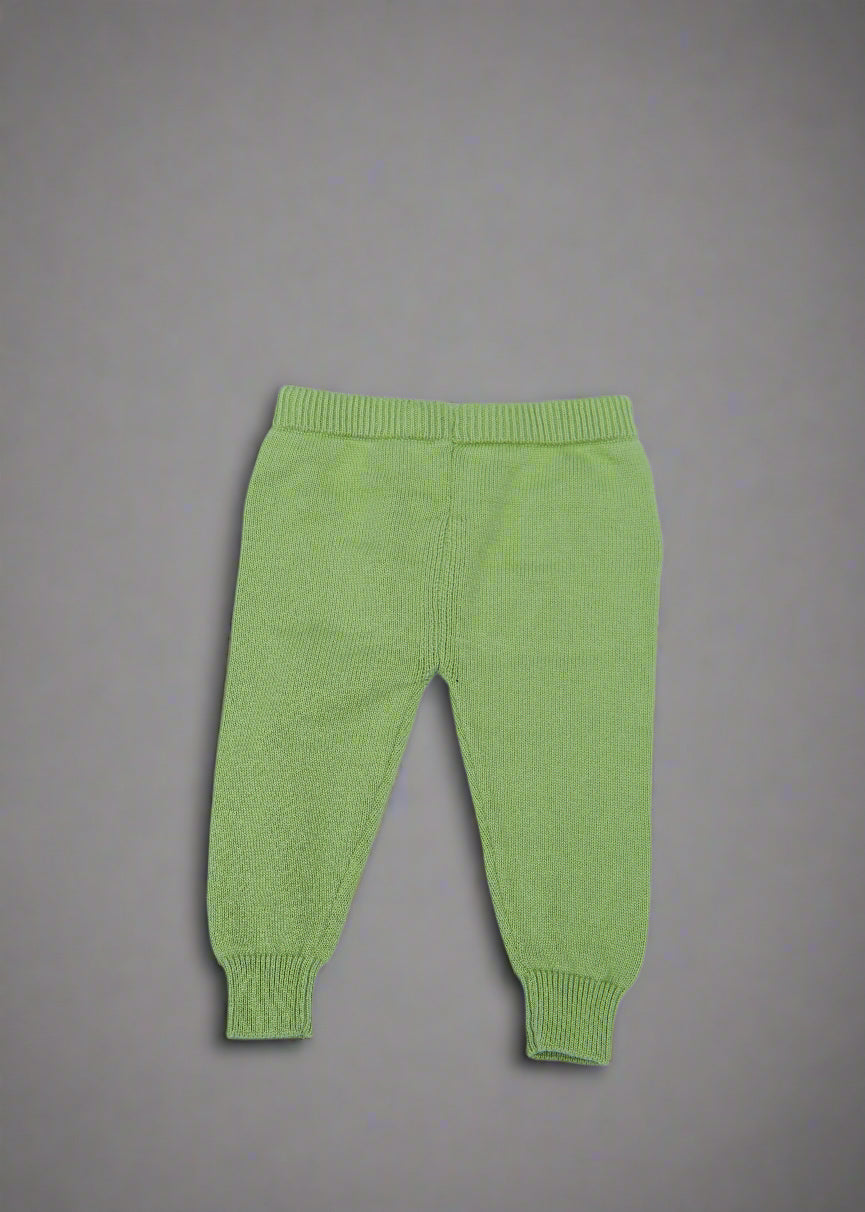 Green baby pants on a light blue background