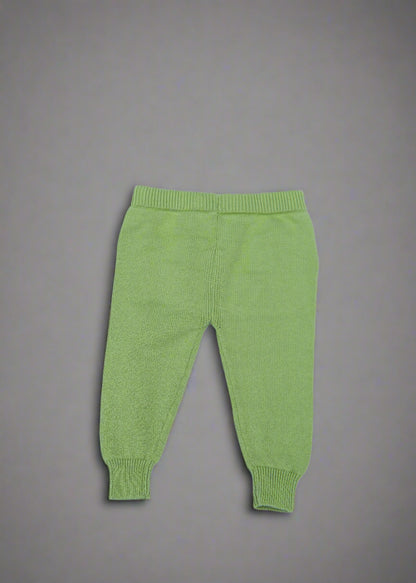Green baby pants on a light blue background