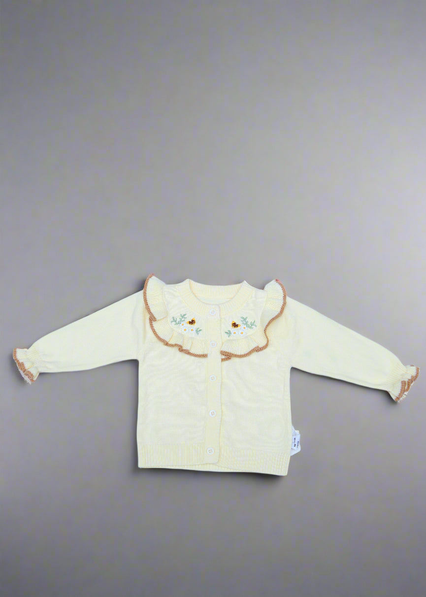 White baby outfit with a hood on a light blue background