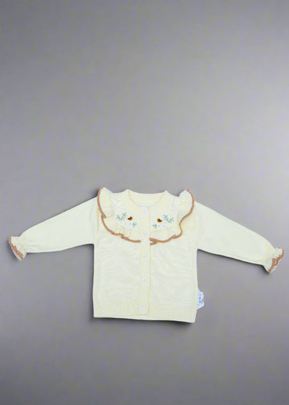 White baby outfit with a hood on a light blue background