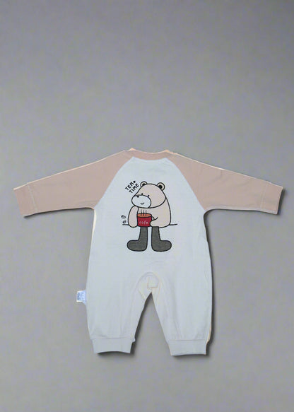 Beige long-sleeve shirt with cartoon design on a light blue background