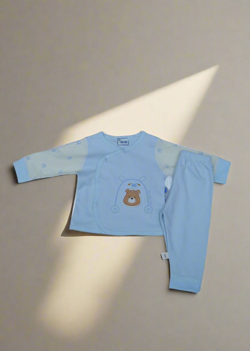 Light blue children's outfit with bear design on a white background