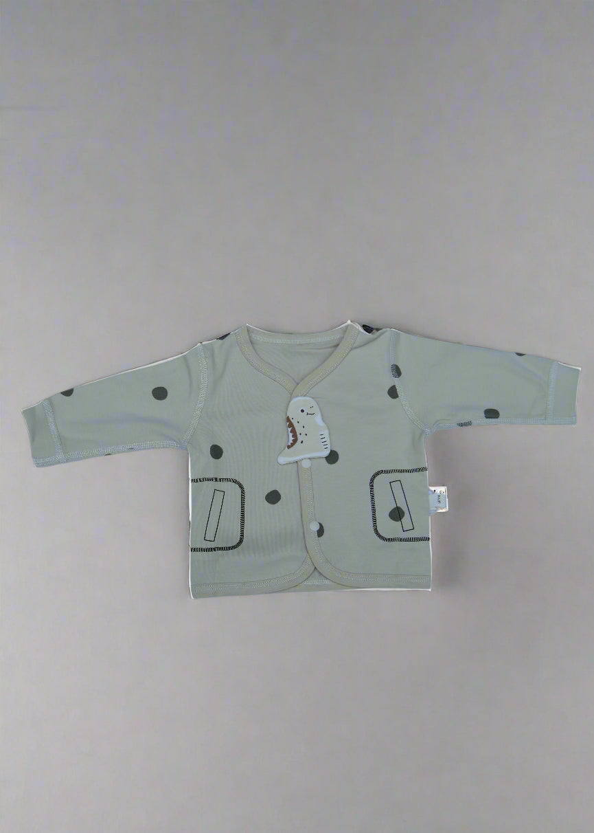 Light-colored baby romper with cartoon designs on a white background