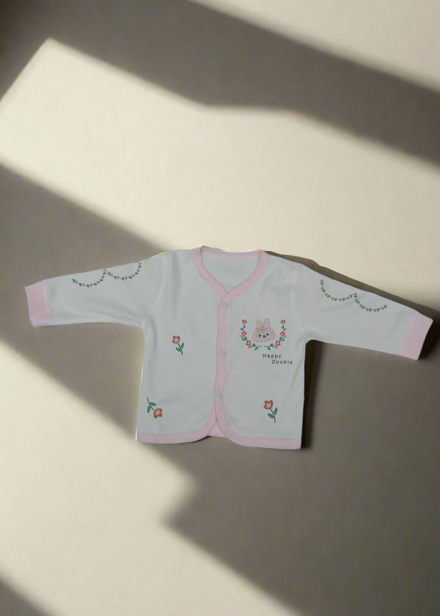 Pair of light-colored underwear with floral embroidery on a light blue background