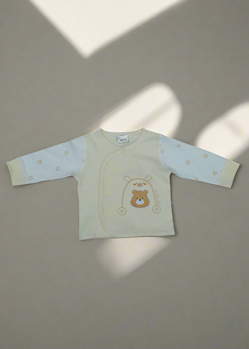 Beige baby outfit with bear design on a light blue background