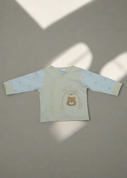 Beige baby outfit with bear design on a light blue background
