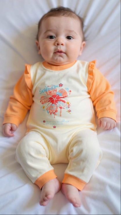 Baby wearing an orange and white outfit with a colorful design on a white background