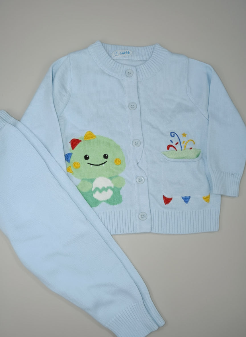Light blue children's sweater and pants set with cartoon character on a beige surface