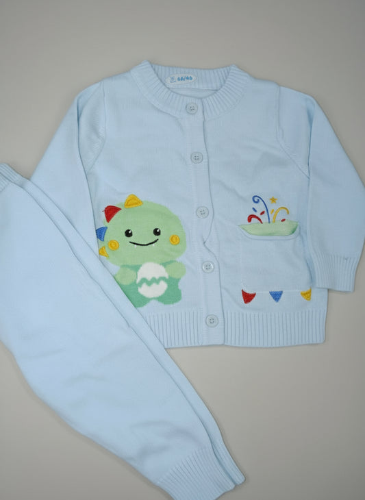 Light blue children's sweater and pants set with cartoon character on a beige surface