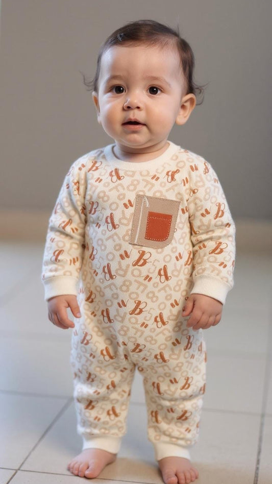 Baby wearing a patterned onesie on a neutral background