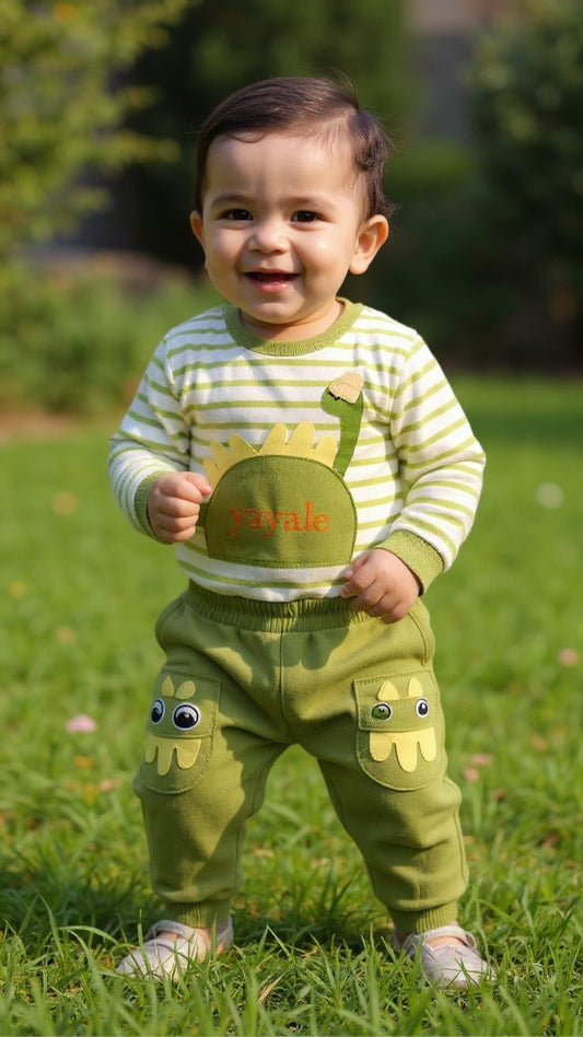 Child wearing a green and white outfit with cartoon character design, standing on grass.