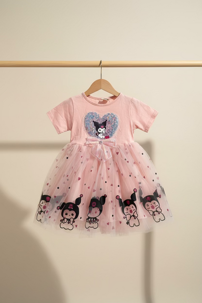 Pink dress with cartoon character design on a light gray surface