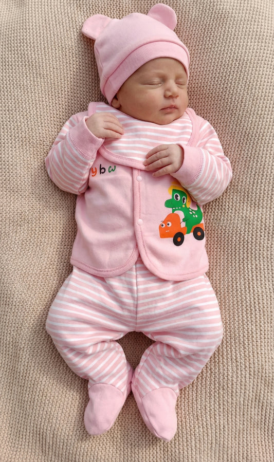 Newborn baby in pink outfit with cartoon design on a beige blanket
