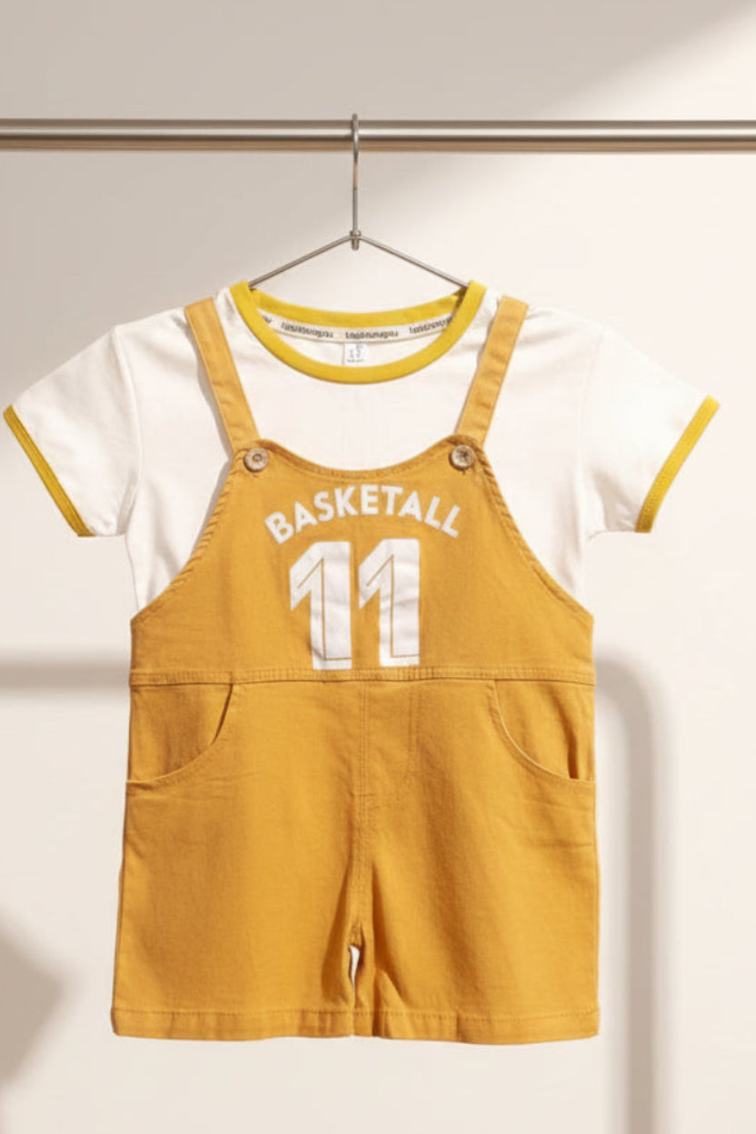 Children's outfit with mustard yellow overalls and white shirt on a colorful background
