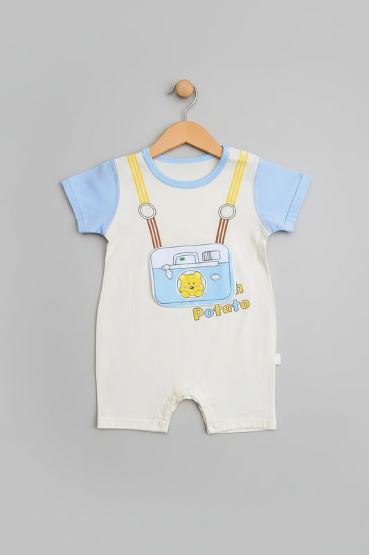 Baby romper with suspenders and camera design on a beige background