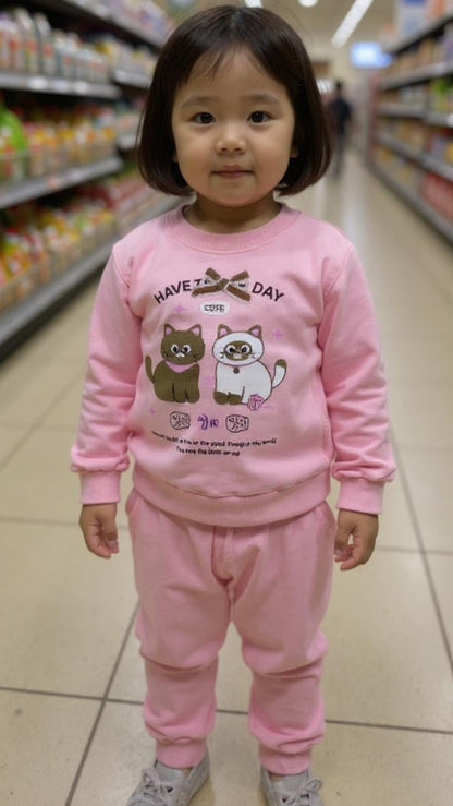 Child wearing a pink outfit with cartoon characters in a supermarket aisle
